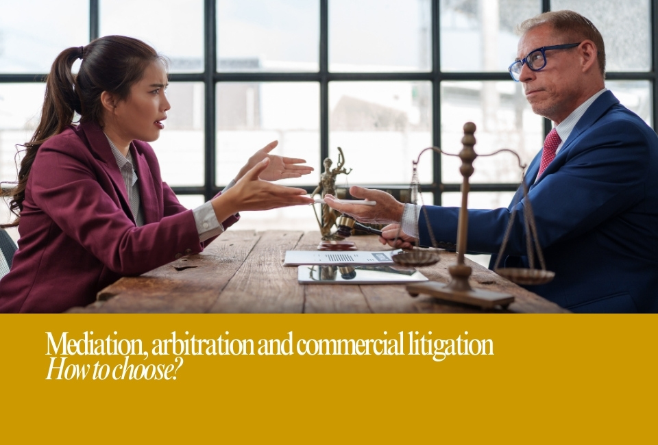 A man and woman. in mediation, arbitration or commercial litigation around a wooden table